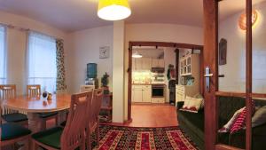 a living room with a table and a dining room at PORTALA Urban Lodge in Rila