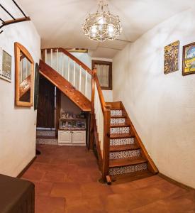 a hallway with a wooden staircase and a chandelier at PORTALA Urban Lodge in Rila