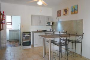a kitchen with a table and some chairs in it at Okajo Safari Lodge in Wilhelmstal