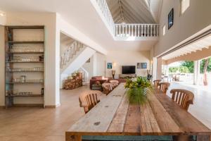 a large wooden table in a living room with chairs at Villa Kas ku Playa 55 - Coral Estate in Willibrordus