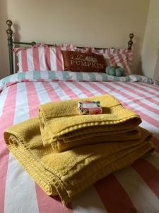 a pile of towels sitting on a bed at Half Pint Cottage in Draperstown
