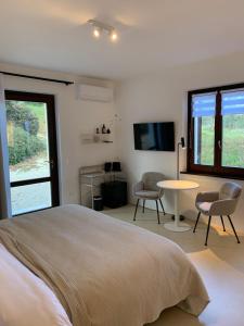 a bedroom with a bed and a table and a tv at Residenza Marrone in Montefalco