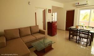 a living room with a couch and a table at Goa Fiesta in Arpora