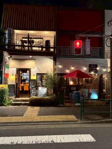 a red traffic light in front of a building at Runbull House in Tokyo