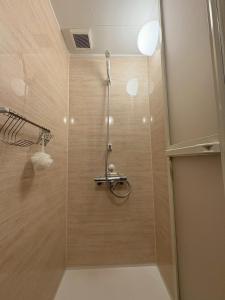 a shower with a glass door in a bathroom at Runbull House in Tokyo +25 photos