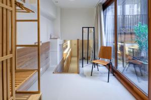 a room with a chair and a desk and a window at Marnix360apartments-Suites Jordaan in Amsterdam +40 photos