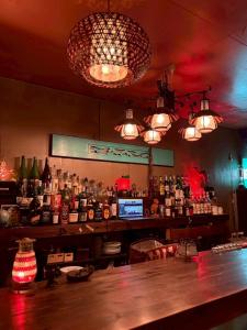 a bar with a lot of bottles of alcohol at Runbull House in Tokyo
