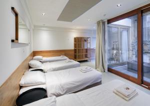 a room with four beds and a balcony at Marnix360apartments-Suites Jordaan in Amsterdam