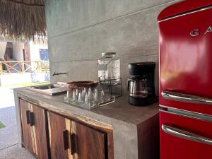 a kitchen with a red refrigerator and a counter at Hotel Almendros Bonfil in Acapulco