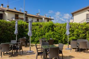 a patio with tables and chairs and umbrellas at Hotel Natura in Castel di Sangro