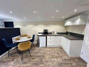 a kitchen with a small table and chairs in a room at The old greengrocers Battlesbridge in Rawreth +20 photos