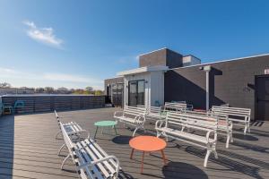 a group of chairs and tables on a deck at The Eighteen by Kasa in Nashville