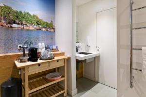 a bathroom with a sink and a shower at Marnix360apartments-Suites Jordaan in Amsterdam
