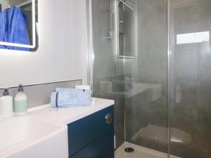 a bathroom with a glass shower and a sink at Leafy Oaks Cabin in Much Wenlock +11 photos