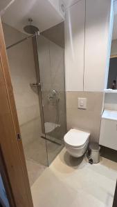a bathroom with a toilet and a glass shower at Apartement LUNA Hotel Zlatni javor in Jahorina