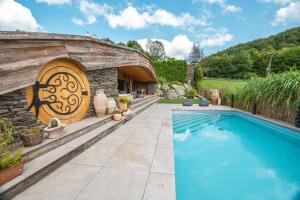a backyard with a swimming pool and a wooden door at Pagórek w Brennej in Brenna