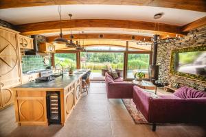 an open kitchen and living room with purple furniture at Pagórek w Brennej in Brenna
