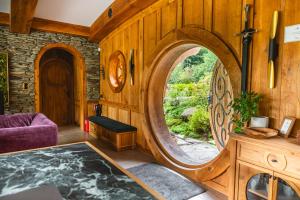a room with a large round window in a room with a table at Pagórek w Brennej in Brenna