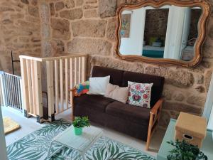 a living room with a couch and a mirror at Casa do Sobrado-Gralhas-Montalegre in Gralhas +35 photos