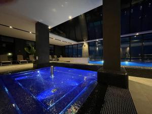 a hot tub in a building with blue lights at Baltic Infinity Garden Suite 316 - SPA & Pool Access in Międzyzdroje