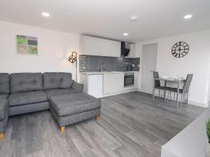 a living room with a couch and a chair and a table at The View - Peaceful Duplex Apartment with Views, Parking & Wifi in Nuneaton +24 photos