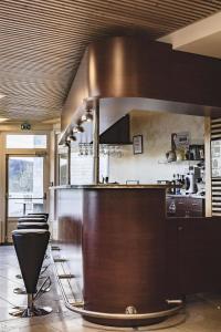 a kitchen with a counter and some chairs in a room at L'Eden du Forez in Le Brugeron