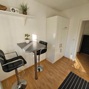 a small room with a table and two chairs at Ferienwohnung Lucia Amorbach in Amorbach +8 photos