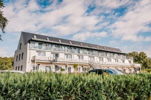 a white building with solar panels on it at Hotel Königslinie in Sassnitz