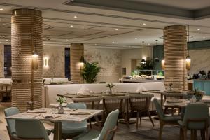 a restaurant with tables and chairs in a room at Amadria Park Grand Hotel 4 Opatijska Cvijeta in Opatija