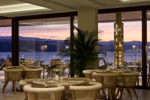 a restaurant with tables and chairs and a view of the water at Amadria Park Grand Hotel 4 Opatijska Cvijeta in Opatija +108 photos