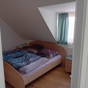 a bedroom with a bed with a wooden head board at Ferienwohnung Dietz in Dießen am Ammersee