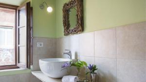 a bathroom with a sink and a mirror on the wall at Montestigliano in Sovicille