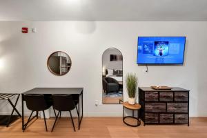 a dining room with a table and chairs and a mirror at Upscale Midtown Studio and Private Balcony in Raleigh +11 photos