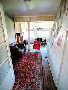 a living room with a red chair and a red rug at Central House in Punta Arenas