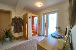 a room with a hallway with a coat hanging on the wall at Volt Egyszer Egy Apartman Pécs in Pécs