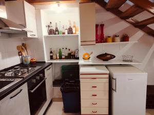 a kitchen with white cabinets and a stove at CASA NATURA - CAMPAGNA e MARE - in Marconia