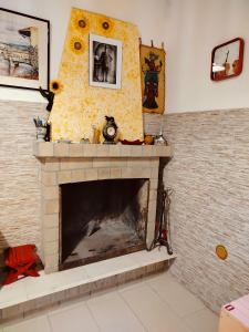 a living room with a brick fireplace with a sunflower at CASA NATURA - CAMPAGNA e MARE - in Marconia