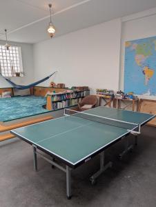 a ping pong table in a room with a classroom at Black Forest Hostel in Freiburg im Breisgau