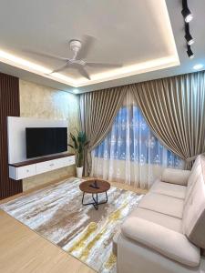 a living room with a couch and a tv at Julia HavenStay, Sepang KLIA in Sepang