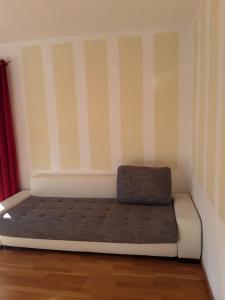 a bed sitting in a room with striped walls at Apartments Steger in Faak am See