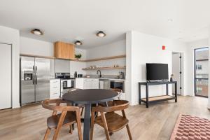 a kitchen and dining room with a table and chairs at The Eighteen by Kasa in Nashville