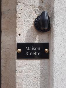 a black sign on the side of a building at Maison Rinette in Dijon