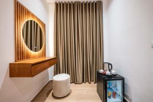 a bathroom with a mirror and a tv in a room at ABEDINI Boutique Hotel Ksamil in Ksamil +155 photos