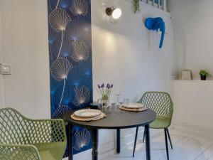 a dining room with a table and two chairs at Le Duplex Cosy in Clermont +19 photos