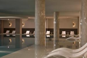 a hotel lobby with a swimming pool and columns at Amadria Park Grand Hotel 4 Opatijska Cvijeta in Opatija