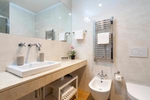a bathroom with a sink and a toilet and a mirror at Chic&Town Luxury Rooms Piazza del Popolo 1 in Rome