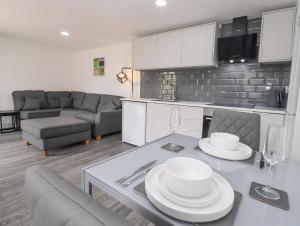 a kitchen and living room with a table and chairs at The View - Peaceful Duplex Apartment with Views, Parking & Wifi in Nuneaton