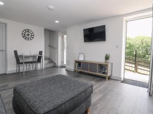 a large living room with a bed and a table at The View - Peaceful Duplex Apartment with Views, Parking & Wifi in Nuneaton