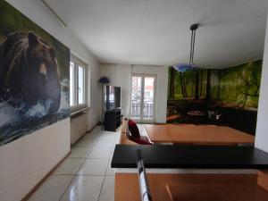 a living room with a large painting on the wall at Superior Apartments Giovannini in Fai della Paganella