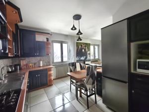 a kitchen with a table and chairs in it at Superior Apartments Giovannini in Fai della Paganella